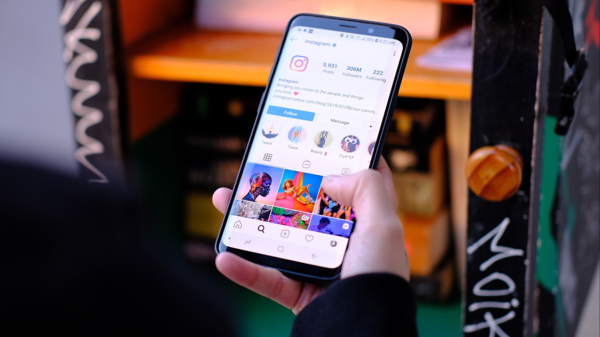 Person holding a phone showing an Instagram page