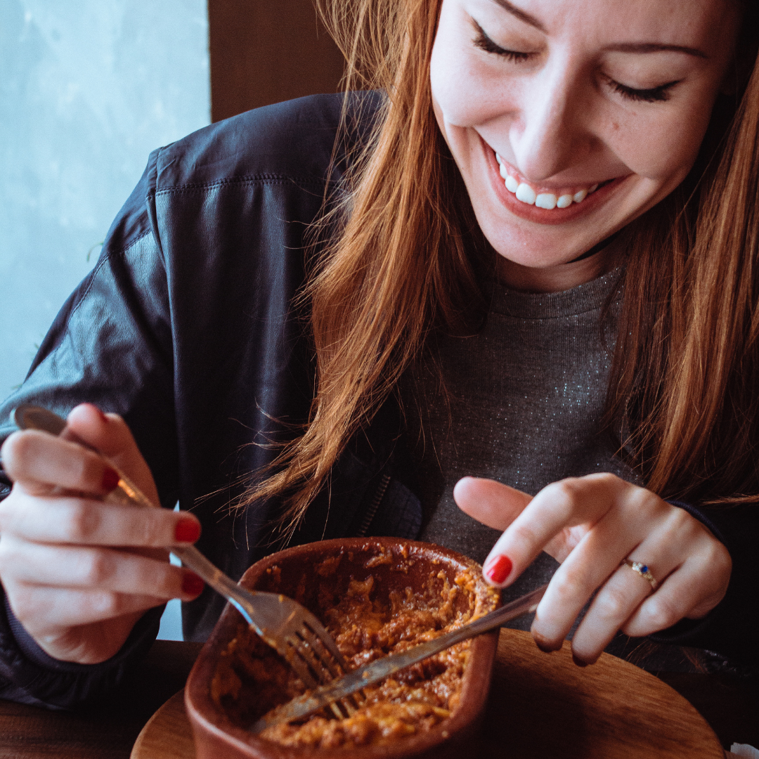 woman eating out of a bowl.