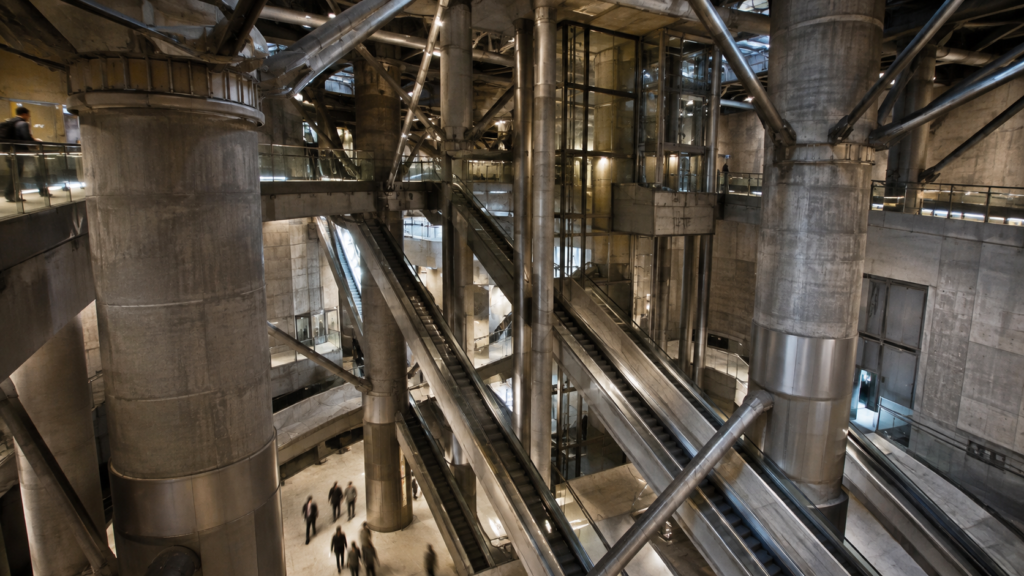 Escalators and concrete columns inside Westminster Underground station's dramatic interchange